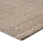 Sutton Natural Solid tan and black area rug with heathered woven texture made from jute, wool, polyester, and viscose