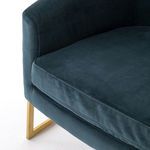 Close-up of Corbin Chair seat cushion corner with velvet upholstery and brass frame