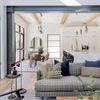 Living room scene with Basis Taupe Rug under gray sofa, near black side table and dining area