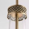 Close-up from below highlighting textured brass mesh band encircling the top part of the glass shade