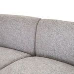View of sectional corner with armrest and cushions angled towards camera