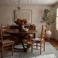 Asha Sky Rug styled under a round wooden dining table with chairs and dried floral centerpiece