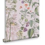Close-up of one rolled edge of Edulis Blush wallpaper highlighting detailed floral patterns and subtle pink backdrop