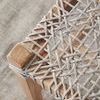 Overhead close-up showing intricate criss-cross pattern of woven rope seat