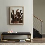 Another view of painting above bench, showing clean modern stair railing and neutral wall