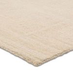 Close-up focusing on hand-tufted wool pile texture and neatly finished edge of the rug
