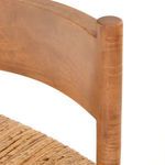 Close-up on joint where wooden backrest meets vertical stool leg