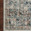 Corner of Bianca Ivory Ocean Rug on dark hardwood floor highlighting woven edge and pattern detail