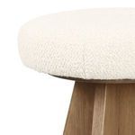Top side close-up of thick round seat with ivory boucle fabric showing stitching detail