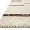 Close-up angled side view of Roman Natural / Bark rug showing texture and stitched edge detail