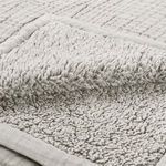 Close-up of folded corner showing thick fluffy sherpa backing texture of throw blanket