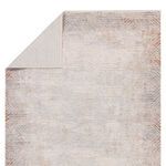 Rug partially flipped to reveal geometric pattern on the reverse side in lighter gray tones