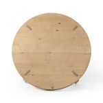 Overhead shot showing full circular tabletop with visible pulls and natural wood marks