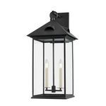 Corning Exterior Wall Sconce in forged iron with four clear glass panels and two candle-style bulbs