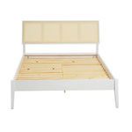Straight-on front view of the white frame and woven cane headboard bed