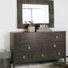 Bedroom styled with Linea dresser, upholstered bed, geometric stools, and textured wall panelling