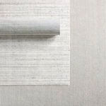 Rolled edge and closely packed looped pile detail in cream and gray tones with black flecks