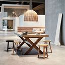 Benji Stool in black paired with light wood stools around a large wooden dining table in a spacious modern room
