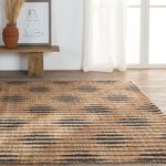Lower angle showing wider view of rug pattern with rustic bench and sheer curtains