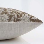 Close-up side view showing pillow cover’s textured fabric and plain beige linen backing