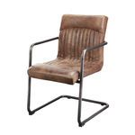 Ansel Arm Chair angled side view showing cantilevered iron frame and leather upholstery texture
