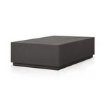 Side angle view of the rectangular slatted outdoor coffee table showing depth and shadowing