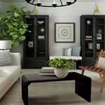 Cascade Coffee Table styled in living room setting with armchair, sofa, plants, and wall art