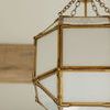 Close-up of gold metal frame and frosted glass texture on Morris Small Lantern pendant