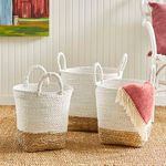 Madura Market baskets styled inside a room on a natural fiber rug with a pink throw blanket draped