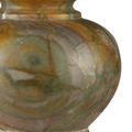 Close-up of base area with green and rust-colored marble veining detail.