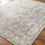 Davina rug angled on wood floor showing flat weave texture and subtle color variations