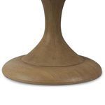 Close-up of round tulip pedestal base showing carved step detailing and wood grain.