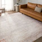 Rug styled in a modern living room with tan leather sofa, round side table, and natural light