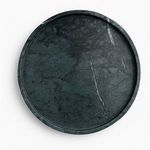 Top-down view showing the marble texture and subtle veining of the dark green round tray