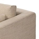 Close-up of top corner back and arm junction showing fabric fit and cushion placement