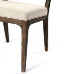 Detailed texture of linen-like stone fabric on chair seat surface