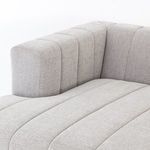 Close-up of sofa back corner highlighting the plump vertical channel upholstery and fabric weave