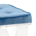 Close-up of the blue velvet tufted cushion showing texture and piping detail