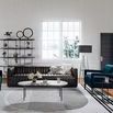 Stylized living room setting with sofa paired with contemporary armchairs and modern decor