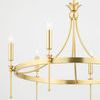 Side angle showing three lit bulbs on gold frame with floral accents and curved supports