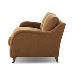 Side profile of Lynne Sofa showing rolled arm shape and turned front leg with caster.
