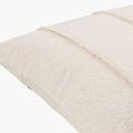 Side angle showing textured vertical lines and smooth cotton back of Mindy Ecru accent pillow