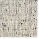 Close-up top-down detail highlighting tight woven wool pattern with cream and gray shades
