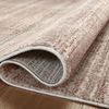 Curled section of Ember Clay / Mist rug revealing flatwoven underside and thin profile