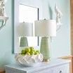 Hive Lamp styled on a blue patterned chest with matching shaped mirror and white decorative birds in a light blue wall room