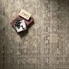 Close-up showing textured vintage motifs and subtle color variations in sage grey and ivory