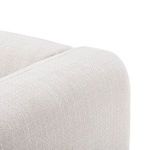 Close-up showing smooth rounded front corner of chair arm with upholstery texture