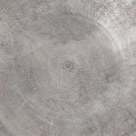 Close-up of tabletop surface showing subtle circular marks and weathered antique nickel texture