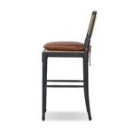 Side view of Fayth stool highlighting backrest woven texture and cushion depth