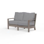 Laguna Loveseat outdoor sofa with hand-brushed driftwood finish aluminum frame and gray seat and back cushions